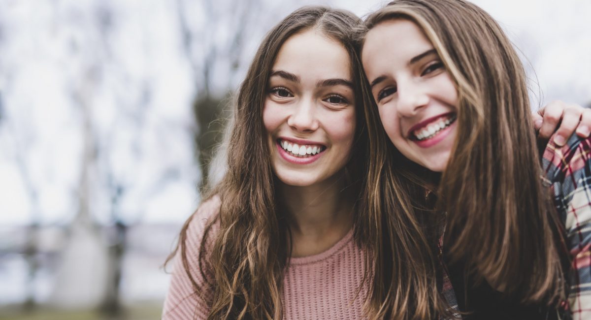 A Portrait of a teen girl with long hair in an urban